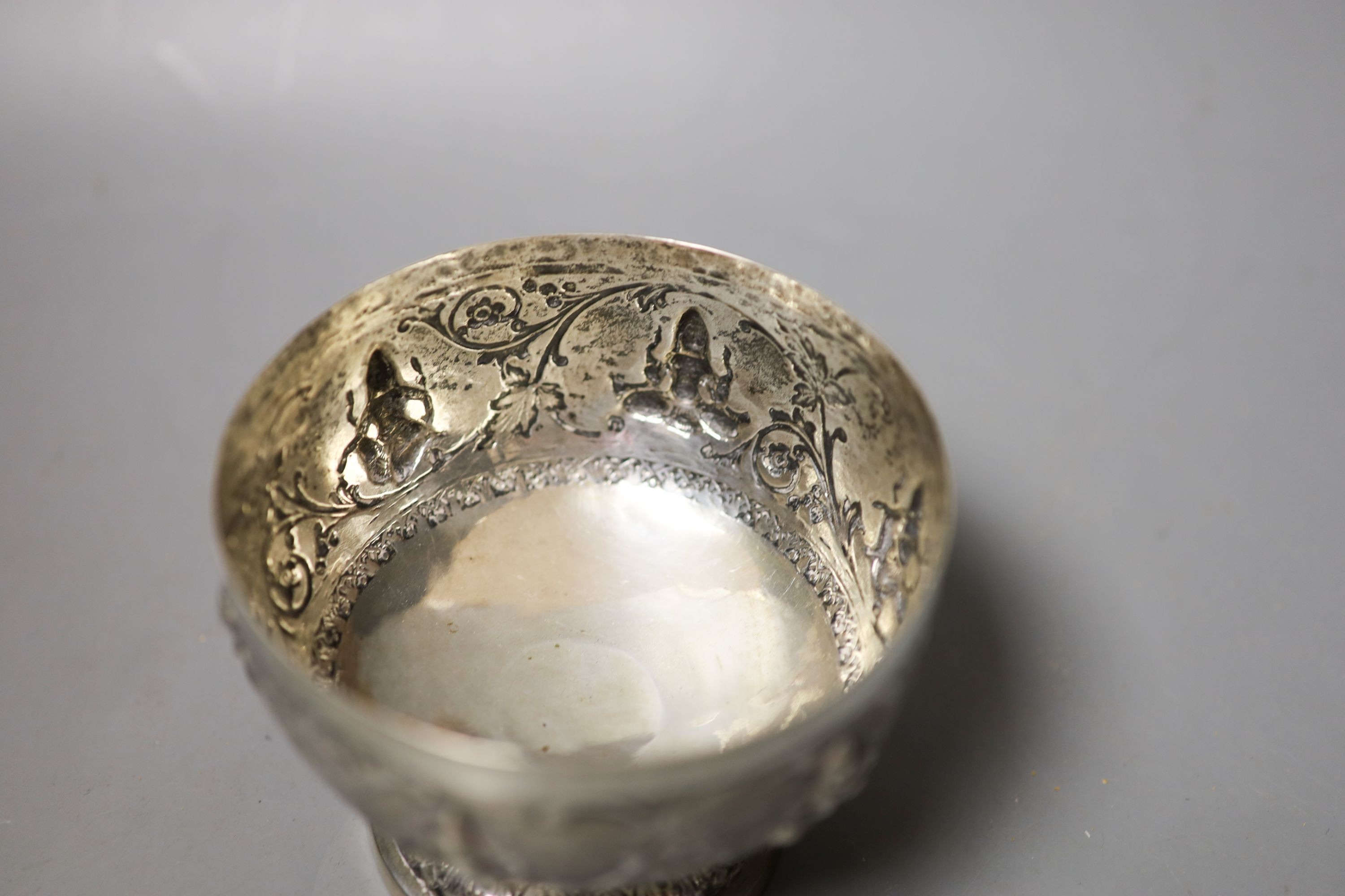 An Indian embossed white metal pedestal bowl, diameter 10.7cm.
